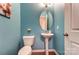 Charming half-bathroom with blue walls, pedestal sink, and modern fixtures at 100 Marabou Ct, Mount Holly, NC 28120