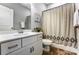 Bathroom featuring modern sink and toilet and decorative shower curtain at 100 Marabou Ct, Mount Holly, NC 28120