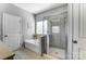 Bathroom featuring a tiled shower, soaking tub, and a large bright window at 100 Marabou Ct, Mount Holly, NC 28120