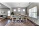 Bright dining room with a modern chandelier and ample natural light at 100 Marabou Ct, Mount Holly, NC 28120