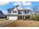 Charming two-story home with a well-maintained front yard, covered porch, and attached two-car garage at 100 Marabou Ct, Mount Holly, NC 28120