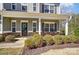 Inviting front porch with decorative plants, stone accents, and comfortable seating, enhancing the home's curb appeal at 100 Marabou Ct, Mount Holly, NC 28120