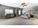 Spacious bedroom featuring a ceiling fan, sitting area and soft, neutral colors at 100 Marabou Ct, Mount Holly, NC 28120