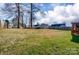 Expansive backyard with shed, privacy fence, mature trees, and deck space for outdoor enjoyment at 10202 Little Whiteoak Rd, Charlotte, NC 28215