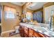 Bathroom with brown vanity, decorative mirror and shower at 10202 Little Whiteoak Rd, Charlotte, NC 28215