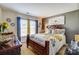 Cozy bedroom with flower patterned bedding and decorative accents at 10202 Little Whiteoak Rd, Charlotte, NC 28215