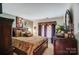 Bedroom suite featuring decorative comforter, dark wood furniture and decorative accents at 10202 Little Whiteoak Rd, Charlotte, NC 28215