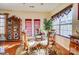 Cozy dining area near a window features a glass table and wooden chairs at 10202 Little Whiteoak Rd, Charlotte, NC 28215