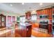 A spacious kitchen features wood cabinets, stainless steel appliances, and a large island at 10202 Little Whiteoak Rd, Charlotte, NC 28215