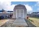 Backyard storage shed with double doors and a wooden pathway provides secure storage at 10202 Little Whiteoak Rd, Charlotte, NC 28215