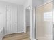 Bright bathroom features a glass enclosed shower, white door, and an open closet at 11331 Breezehill Ln, Charlotte, NC 28262