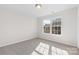 Bedroom showcasing neutral carpet, a well-lit space, and an inviting window providing ample natural light at 11331 Breezehill Ln, Charlotte, NC 28262