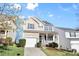 Charming two-story home with a well-maintained lawn, attached garage, and covered front porch at 11331 Breezehill Ln, Charlotte, NC 28262