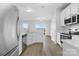 Bright kitchen featuring stainless steel appliances, granite countertops and light laminate floors at 11331 Breezehill Ln, Charlotte, NC 28262