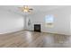 Bright living room features a modern fireplace, light laminate floors, and plenty of natural light at 11331 Breezehill Ln, Charlotte, NC 28262