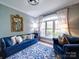 Cozy living room featuring a large window, blue furnishings, and an eye-catching patterned rug at 120 Shadow Ridge Ct, Statesville, NC 28677