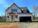 New construction home featuring a two-car garage and covered porch at 128 Kepli Way, Mooresville, NC 28115