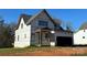 Unfinished home showing the two-car garage and covered porch at 128 Kepli Way, Mooresville, NC 28115