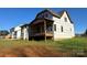 Rear exterior of home with covered porch and windows at 128 Kepli Way, Mooresville, NC 28115