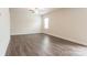 Light-filled bedroom offers wood-look floors and a ceiling fan to maximize comfort and style at 131 Jacobs Hill Pl, Troutman, NC 28166