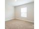 Carpeted bedroom featuring neutral walls and a window at 131 Jacobs Hill Pl, Troutman, NC 28166