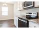 Modern kitchen features stainless steel appliances, granite countertops, and ample cabinet space at 131 Jacobs Hill Pl, Troutman, NC 28166