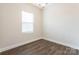 Bedroom with light-colored walls and hardwood floors at 145 Jacobs Hill Pl, Troutman, NC 28166