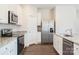 Kitchen featuring granite countertops, white cabinetry, stainless appliances, and luxury vinyl flooring at 145 Jacobs Hill Pl, Troutman, NC 28166