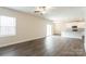 Open-concept living space with luxury vinyl flooring, neutral paint, a ceiling fan, and slider to the backyard at 145 Jacobs Hill Pl, Troutman, NC 28166