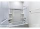 Bathroom showing a pristine white tub and shower combo with convenient shelving at 1453 Ardmore Dr # 240, Sherrills Ford, NC 28673