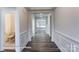 Inviting hallway showcasing wood-look flooring and wainscoting leading to a bathroom and open area at 1453 Ardmore Dr # 240, Sherrills Ford, NC 28673