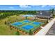 Aerial view of four tennis courts, a pool, and the community clubhouse amidst green landscape at 1453 Ardmore Dr # 240, Sherrills Ford, NC 28673