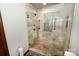 Walk-in shower with glass door, seat, and unique tiling details at 1793 Fairway Dr, Newton, NC 28658