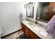 Bathroom featuring dual sinks, modern mirrors, and vanity with granite countertops at 1793 Fairway Dr, Newton, NC 28658