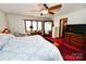 Large bedroom featuring a ceiling fan, red carpet, and natural light from the window at 1793 Fairway Dr, Newton, NC 28658
