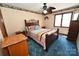 Bedroom features ceiling fan, patterned wallpaper border, and a bright window at 1793 Fairway Dr, Newton, NC 28658