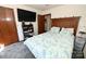 Cozy bedroom with gray carpet, blue floral comforter, TV, and bedside table at 1793 Fairway Dr, Newton, NC 28658
