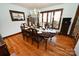 Dining room features natural lighting through a large window, with hardwood floors and a table set for dinner at 1793 Fairway Dr, Newton, NC 28658