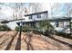 Charming home with a brick path leading to the covered entrance, surrounded by mature trees at 1793 Fairway Dr, Newton, NC 28658