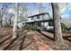 Charming home with a brick path leading to the covered entrance, surrounded by mature trees at 1793 Fairway Dr, Newton, NC 28658