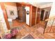 Warm foyer with a brick fireplace, hardwood floors, and a staircase with decorative floral wallpaper at 1793 Fairway Dr, Newton, NC 28658