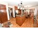 A kitchen island with granite countertop is complimented by wood flooring and cabinetry at 1793 Fairway Dr, Newton, NC 28658
