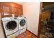 Laundry room with wood cabinets and side-by-side washer and dryer at 1793 Fairway Dr, Newton, NC 28658