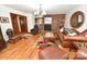 Warm living room featuring a brick fireplace, hardwood floors, and comfortable seating at 1793 Fairway Dr, Newton, NC 28658