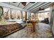 Inviting covered patio with stone floors, a ceiling fan, and a view of the backyard deck at 1793 Fairway Dr, Newton, NC 28658