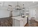 Elegant kitchen with marble countertops, modern pendant lighting, and a view into the dining area and living room at 2081 Fordhill St, Rock Hill, SC 29732