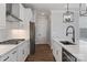 Bright kitchen featuring stainless steel appliances, white cabinets, an island with a sink, and hardwood floors at 2081 Fordhill St, Rock Hill, SC 29732