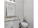 Cozy bathroom featuring vanity with granite counters, a toilet, and a framed mirror at 2082 Egret Ct, Rock Hill, SC 29732