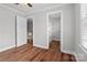 Bedroom with hardwood floors, a closet, and a view into the hallway, plus a big window at 2082 Egret Ct, Rock Hill, SC 29732