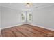 Spacious bedroom with natural light, tray ceiling, and hardwood floors at 2082 Egret Ct, Rock Hill, SC 29732